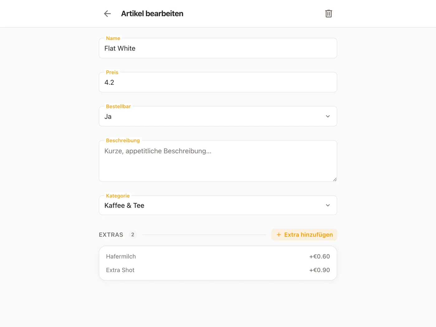 Ein Artikel geöffnet in Platevio, auf Artikel bearbeiten: Name und Preis des Flat White, Bestellbar auf Ja, eine leere Beschreibung, seine Kategorie für Kaffee und Tee und seine zwei Extras, Hafermilch und Extra Shot, mit ihren Preisen