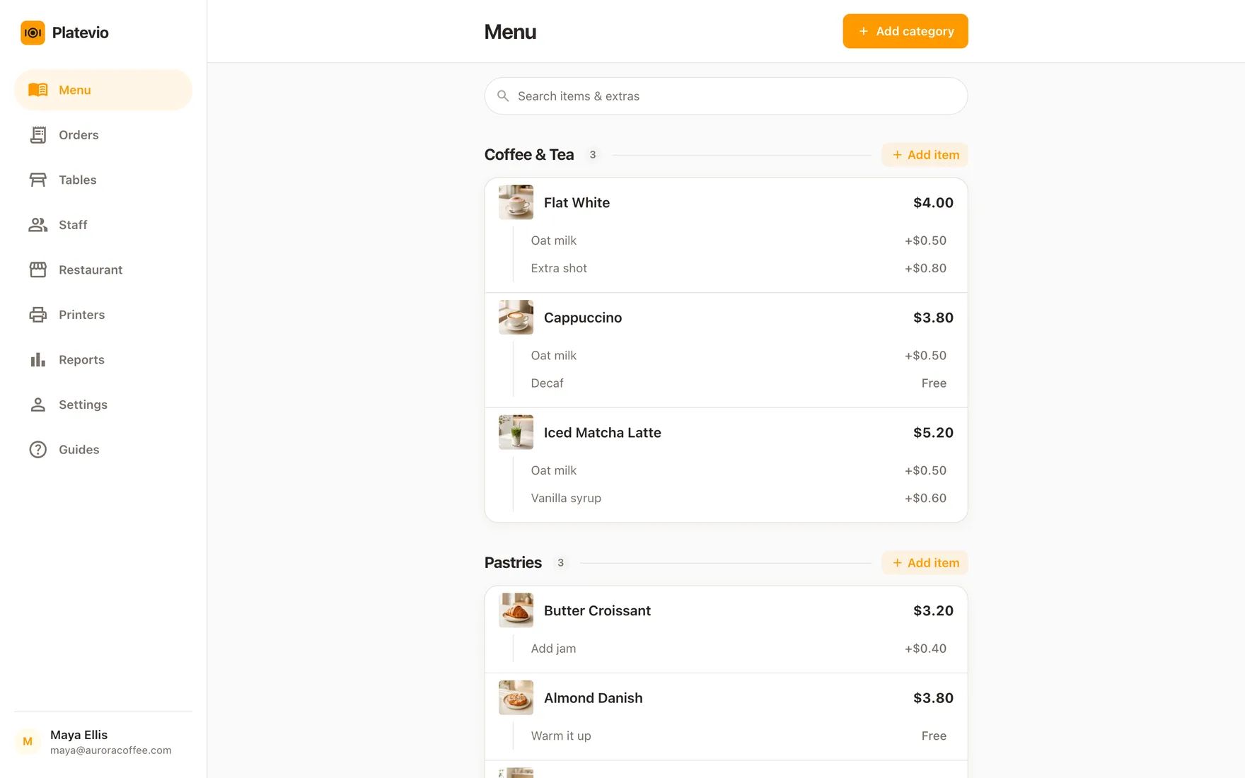 The Platevio restaurant POS open in a browser on a laptop: a cafe menu with photos, prices and extras