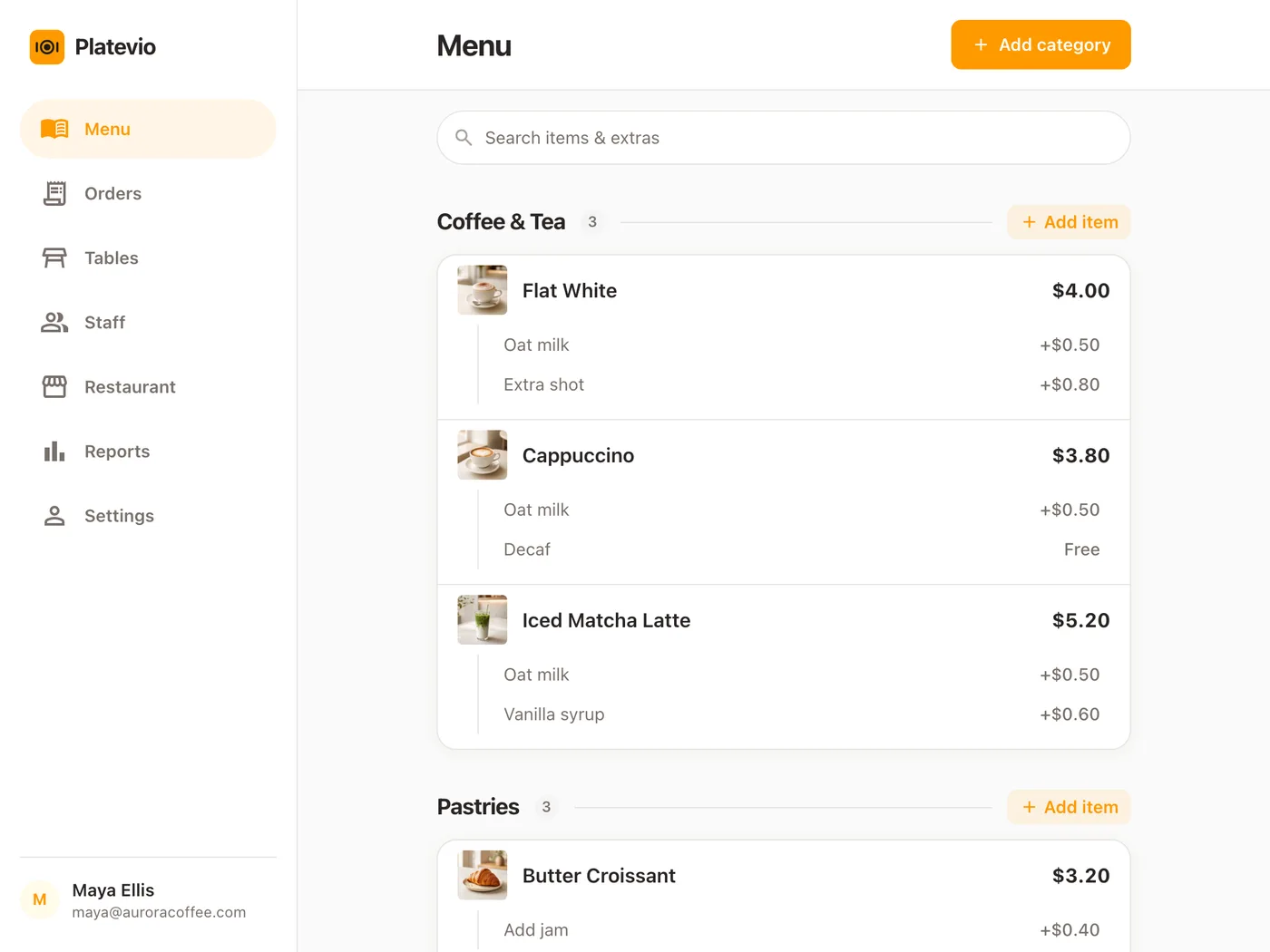 A cafe menu open in Platevio on a counter tablet, with photos, prices and extras