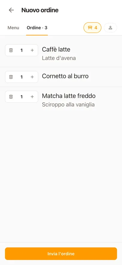 Una comanda al bar sul telefono: un flat white con latte di avena, un cornetto e un matcha freddo con sciroppo di vaniglia, pronti da inviare