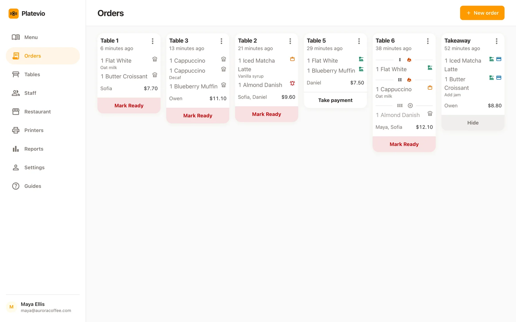The Platevio Orders board in a browser on the bakery’s laptop: every open check as a ticket card, each item with its extras and its status
